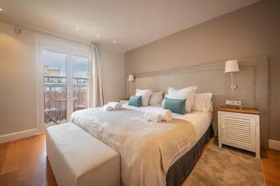 a bedroom with a large bed with towels on it at Ático dúplex con cinco dormitorios in Barcelona