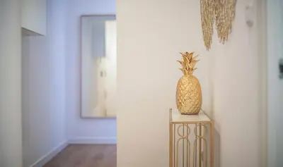 a pineapple sitting on a table in a room at Apartamento de cuatro dormitorios en Calle Aribau You Stylish Apartments in Barcelona