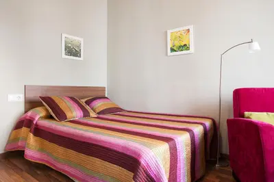 a bedroom with a bed with a striped blanket at El Born Apartment - Santa Caterina Market - Walk to Cathedral & Picasso Museum in Barcelona