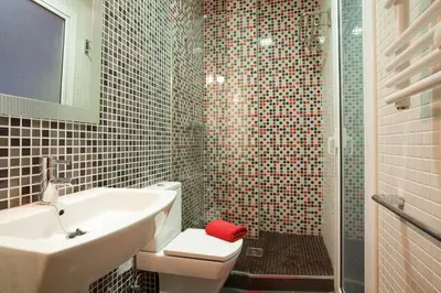 a bathroom with a sink and a toilet and a shower at El Born Apartment - Santa Caterina Market - Walk to Cathedral & Picasso Museum in Barcelona