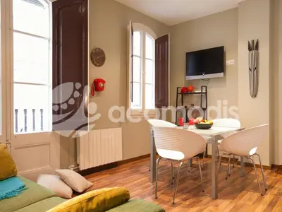 a living room with a table and chairs at El Born Apartment - Santa Caterina Market - Walk to Cathedral & Picasso Museum in Barcelona