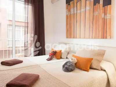 two beds with stuffed animals on them in a bedroom at Ideal Location in L'Eixample! - Walk to Sagrada Familia and Barcelona Old Town! in Barcelona