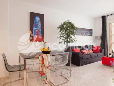 a living room with a table and a couch at Ideal Location in L'Eixample! - Walk to Sagrada Familia and Barcelona Old Town! in Barcelona