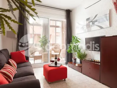 a living room with a couch and a red table at Ideal Location in L'Eixample! - Walk to Sagrada Familia and Barcelona Old Town! in Barcelona