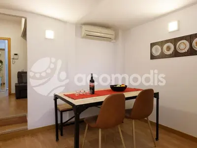 a dining room with a table and two chairs at Great and nice 1 bedroom apartment close to Camp Nou in Barcelona