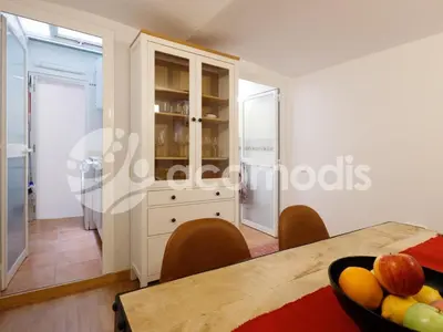 a room with a table with a bowl of fruit at Great and nice 1 bedroom apartment close to Camp Nou in Barcelona