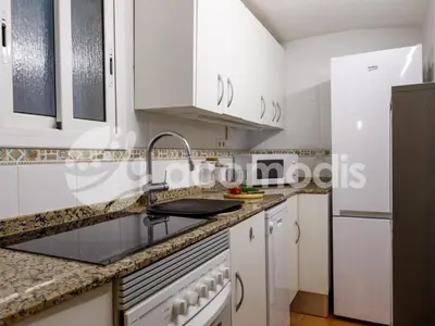 a kitchen with white cabinets and a sink at Great and nice 1 bedroom apartment close to Camp Nou in Barcelona