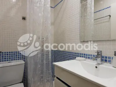a bathroom with a toilet and a sink and a mirror at Great and nice 1 bedroom apartment close to Camp Nou in Barcelona