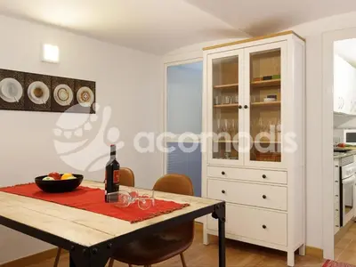 a dining room with a table with a bottle of wine at Great and nice 1 bedroom apartment close to Camp Nou in Barcelona