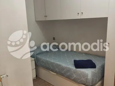 a bedroom with a bed with a sign on the wall at Passatge Concepcio in Hospitalet de Llobregat