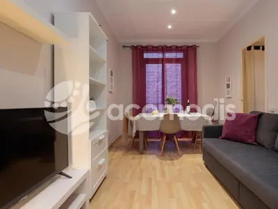 a living room with a couch and a table at Vigatans in Barcelona