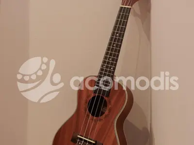 a wooden guitar is leaning against a wall at Vigatans in Barcelona