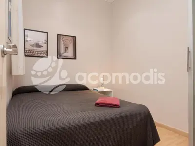 a bedroom with a bed with a red towel on it at Vigatans in Barcelona