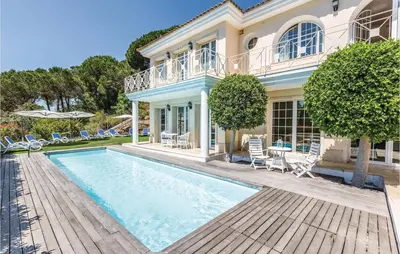 a house with a swimming pool in front of a house at 5 Bedroom Amazing Home In Cabrils in Cabrils