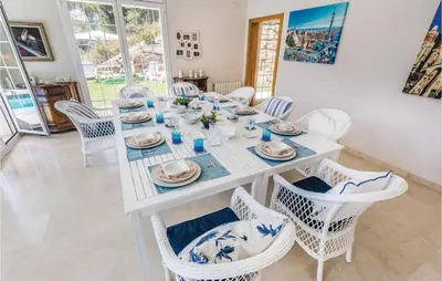 a white dining room with a white table and chairs at 5 Bedroom Amazing Home In Cabrils in Cabrils