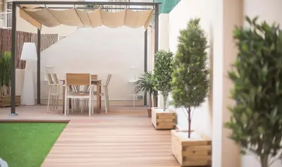 a patio with trees and a table and chairs at Apartamento 4 dormitorios en Calle Roselló You Stylish Apartments in Barcelona
