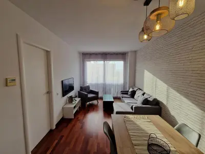 a bedroom with a bed with two towels on it at La Tranquilidad en Sabadell in Sabadell