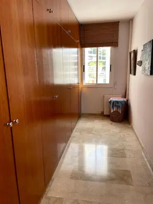 a hallway with a wooden door and a window at Entire villa with pool, ocean & mountain views in Sitges