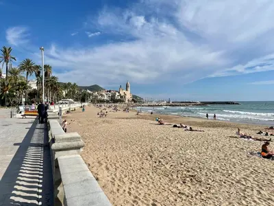 a view of the ocean from a pier at sunset at Entire villa with pool, ocean & mountain views in Sitges