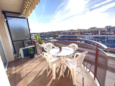 a balcony with a white table and chairs at CUNIT PLaYA in Cunit