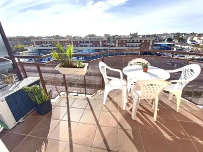 a patio with two tables and chairs on a balcony at CUNIT PLaYA in Cunit