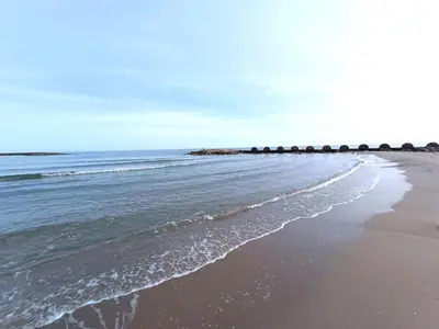a beach with a line of rocks in the ocean at CUNIT PLaYA in Cunit