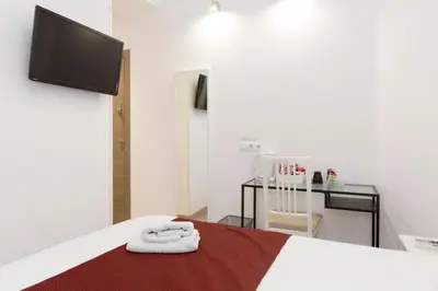 a room with a bed with two towels on it at BruStar Sagrada Familia in Barcelona