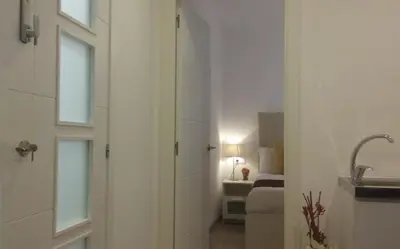 a bathroom with a door leading to a bedroom at BruStar Sagrada Familia in Barcelona