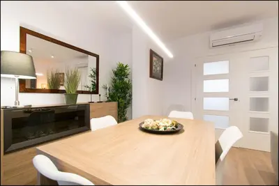 a dining room with a table and a mirror at Sitges Oasi in Sitges