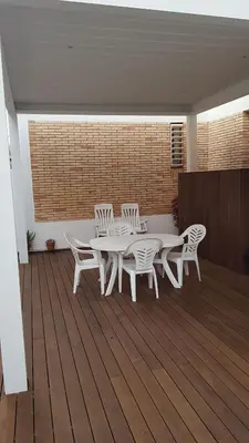 a patio with a table and chairs on a deck at Sitges Oasi in Sitges