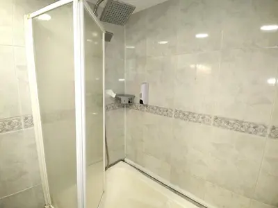 a shower with a glass door in a bathroom at Spacious aptmt close to Pl Universidad and Pl Catalunya, 2,5 bedrooms, balcony, heating, elevator Min 31 nights in Barcelona