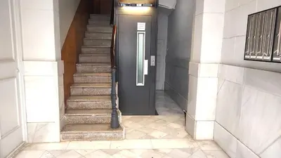 a hallway with a black door and stairs at Spacious aptmt close to Pl Universidad and Pl Catalunya, 2,5 bedrooms, balcony, heating, elevator Min 31 nights in Barcelona
