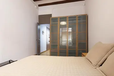 a bedroom with a bed and a glass cabinet at ApartEasy - PURE GRACIA, excellent location in Barcelona