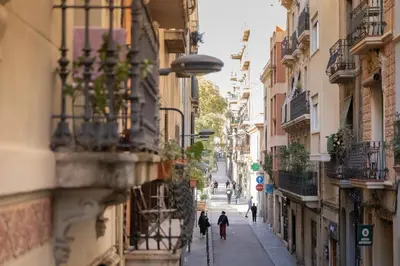 a city street with people walking down the street at ApartEasy - PURE GRACIA, excellent location in Barcelona