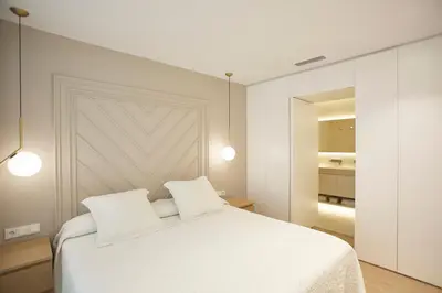 a bedroom with a white bed with two pillows at Apartamento en Pedralbes in Barcelona