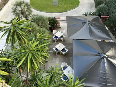 an overhead view of a patio with chairs and an umbrella at Apartamento en Pedralbes in Barcelona