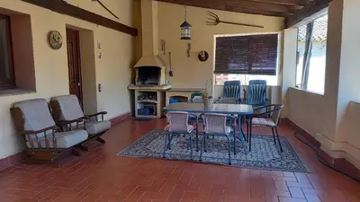 a dining room with a table and chairs and a fireplace at Can Bicicleta de Dalt in Olesa de Bonesvalls