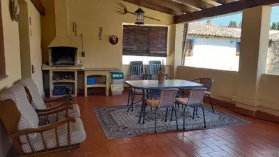 a dining room with a table and chairs and a fireplace at Can Bicicleta de Dalt in Olesa de Bonesvalls