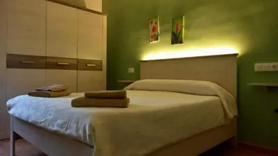 a bedroom with a bed with two towels on it at Can Bicicleta de Dalt in Olesa de Bonesvalls