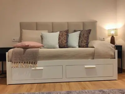 a couch with pillows on it in a living room at Gran Vía de Carlos III B in Barcelona