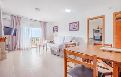 a living room with a table and a couch at Cozy Home In Calafell With Wifi in Calafell