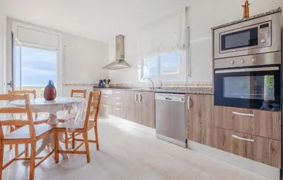 a kitchen with a table and a dining room at Cozy Home In Calafell With Wifi in Calafell