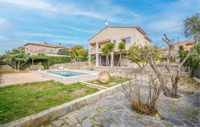a house with a swimming pool in a yard at Cozy Home In Calafell With Wifi in Calafell