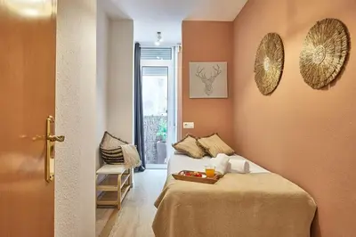 a room with a bed with a tray of food on it at BBarcelona Mallorca Flats in Barcelona