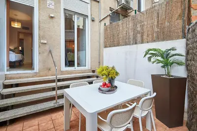 a white table and chairs on a patio at BBarcelona Mallorca Flats in Barcelona