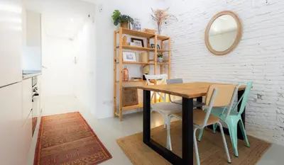 a dining room with a wooden table and chairs at Stay U-nique Apartments Llibertat in Barcelona