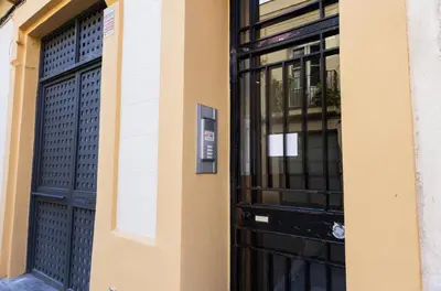 a black door on a building with black windows at Stay U-nique Apartments Llibertat in Barcelona