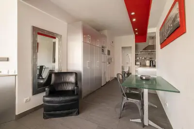 a kitchen and dining room with a table and chairs at Stay U-nique Apartment Creu Coberta in Barcelona