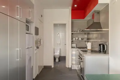 a small kitchen with a toilet and a sink at Stay U-nique Apartment Creu Coberta in Barcelona