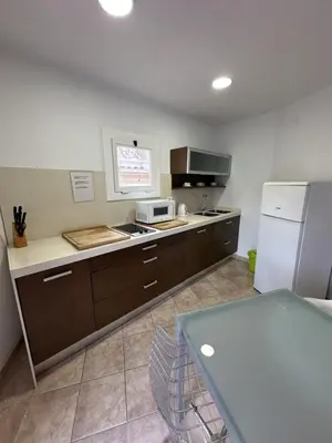 a kitchen with a microwave and a refrigerator at LEsglesia 1 in Arenys de Mar